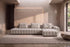 The Lucca Chaise Sofa in oatmeal textured weave in a plaster-walled living room with a garden view