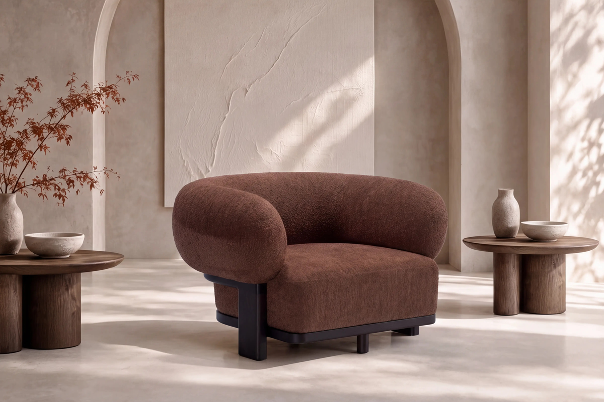 The Matera Accent Chair in cocoa bouclé in a plaster-walled living room