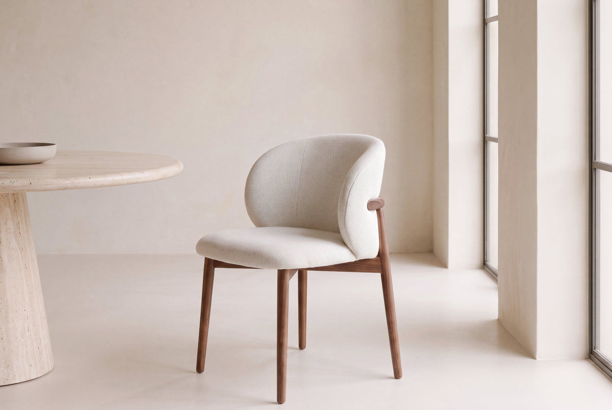 The Norcia Dining Chair at a travertine dining table