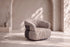 The Orvieto Swivel Chair in textured fabric in a living room