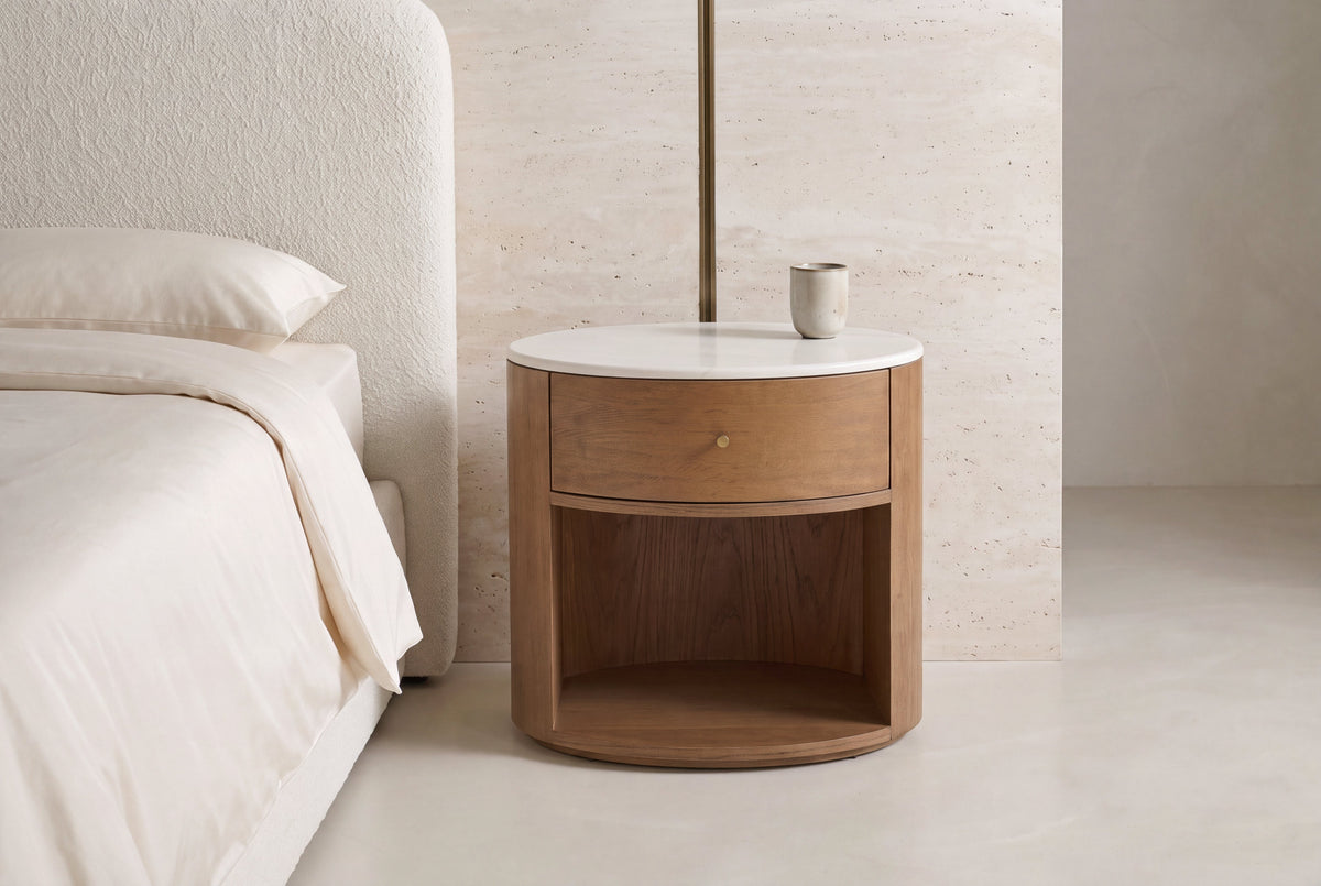 The Ostuni Oak and Stone Bedside Table in a bedroom setting