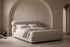 The Positano Bed in oatmeal textured weave in an arched plaster bedroom