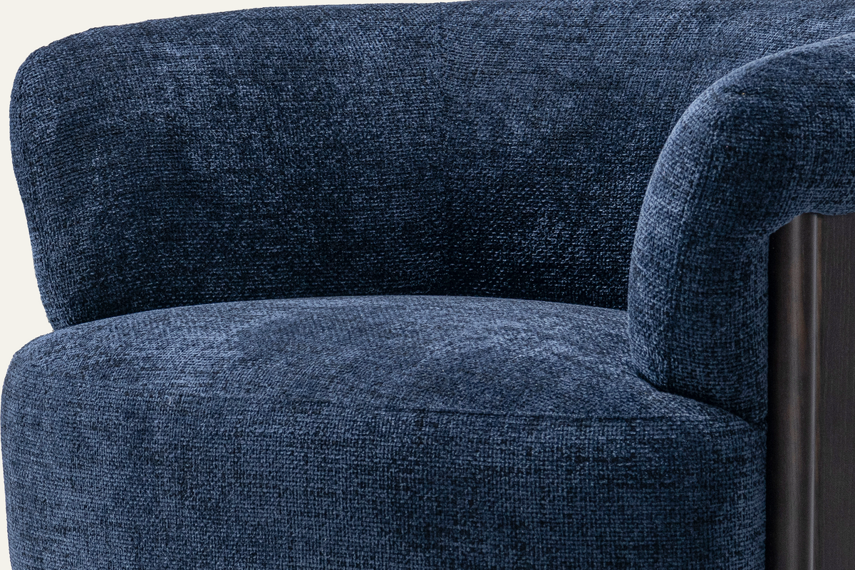 The Ravello Accent Chair, close-up of the navy chenille and dark wood leg