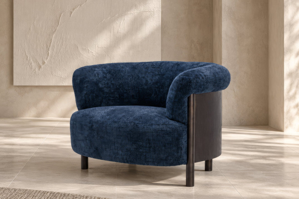The Ravello Accent Chair in navy chenille with a curved dark wood frame