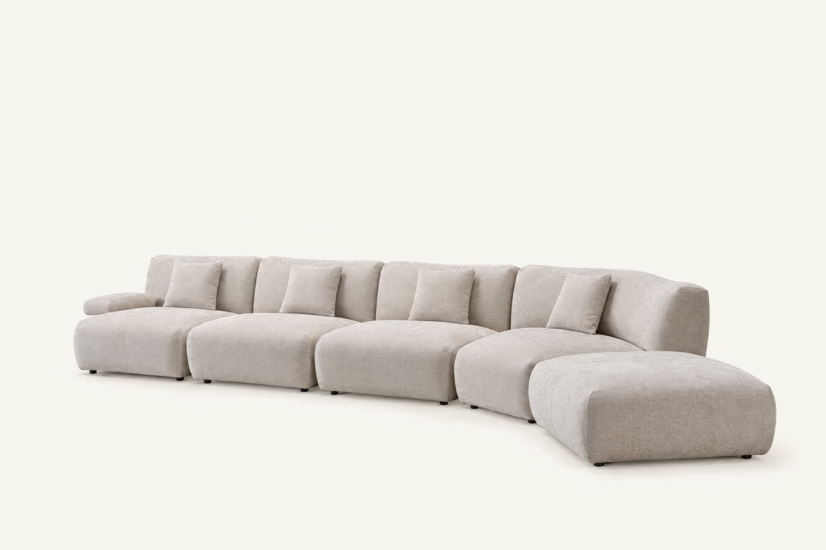 The Solaro Modular Sofa in oatmeal chenille with matching cushions, four seats curving into an ottoman, angled view