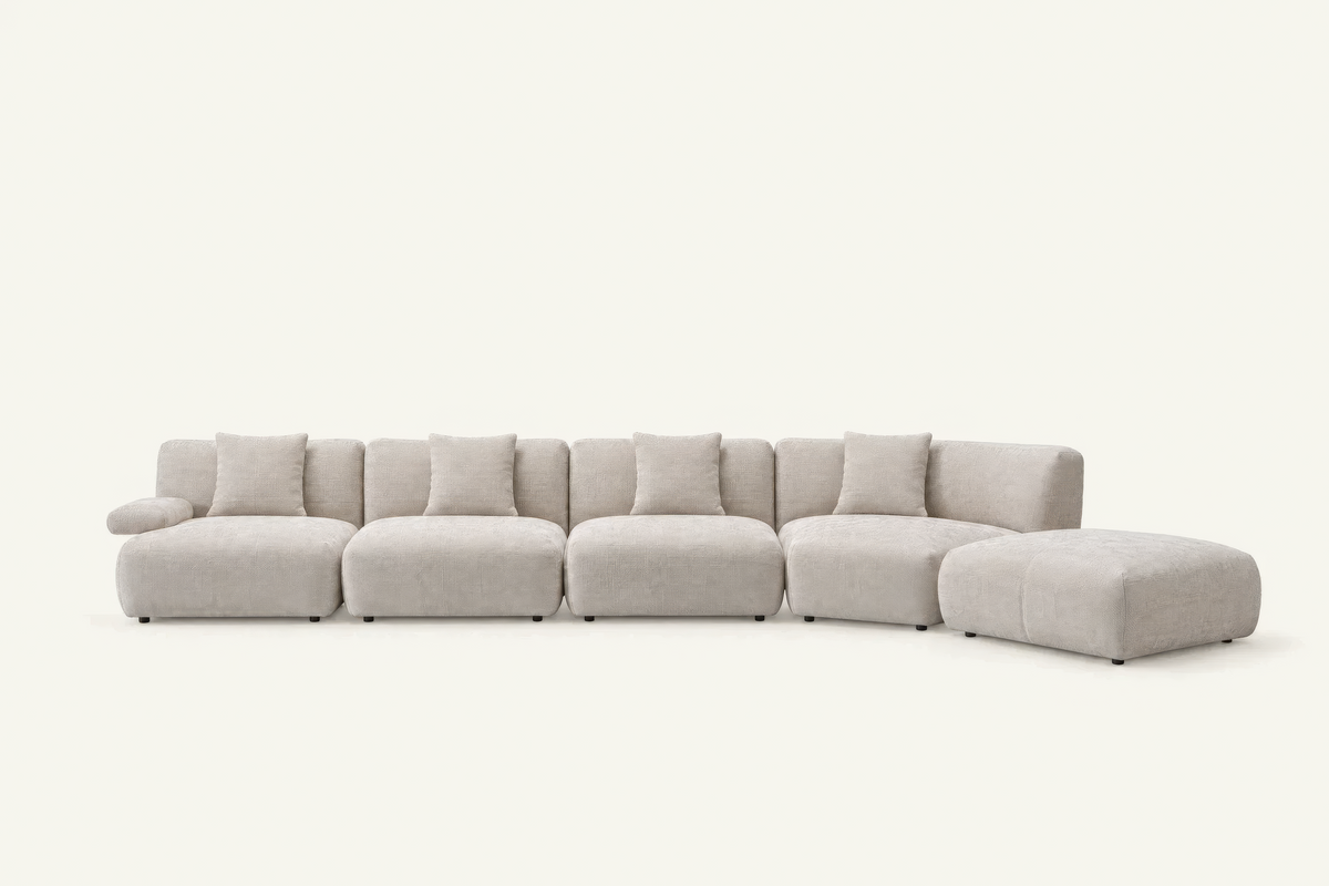 The Solaro Modular Sofa in oatmeal chenille with matching cushions, four seats with ottoman, front view