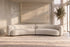 The Sorella Chaise Sofa in ivory boucle in front of a travertine wall slab