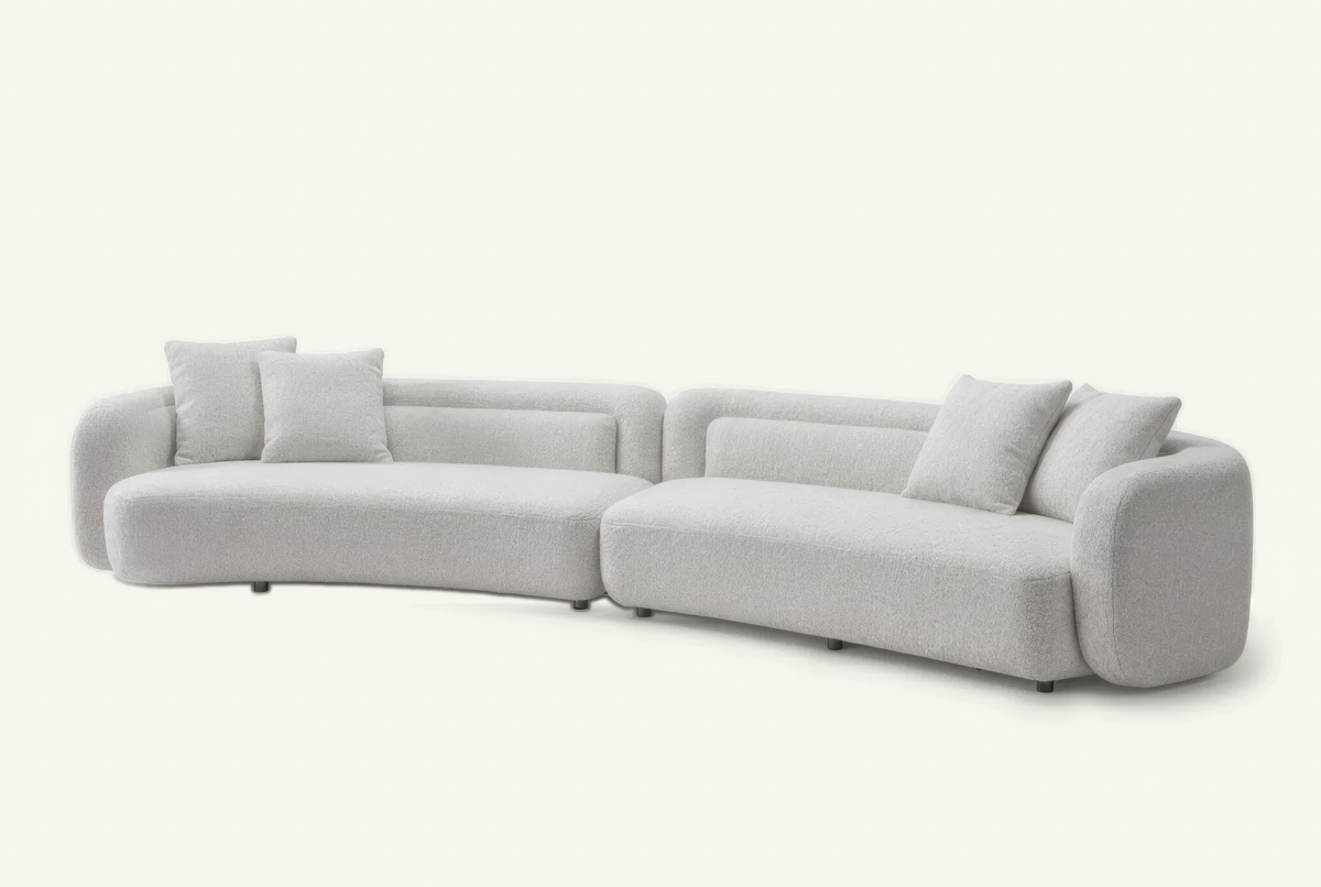 The Sorella Chaise Sofa in ivory bouclé with matching cushions, angled view