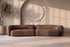 The Sorella Sofa in a warm brown boucle in a plaster room with an arched niche