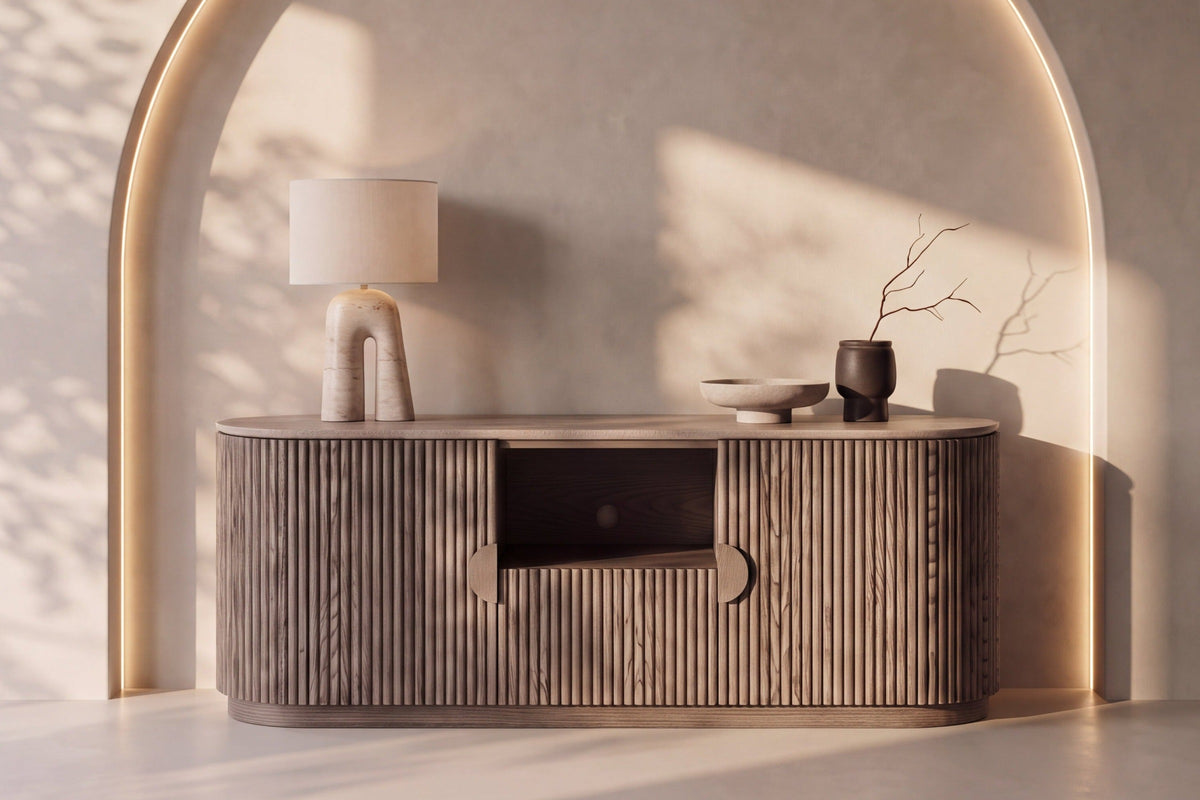 The Spello Fluted Travertine Sideboard beneath a softly lit plaster arch
