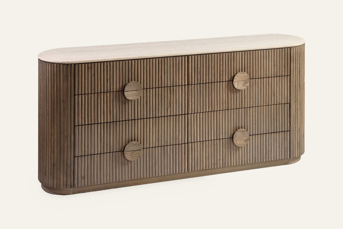 The Spello Fluted Travertine Wide Chest of Drawers, angled view