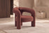 The Terracina Accent Chair in rust bouclé in a warm plaster living room