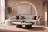 The Varenna Sofa with The Caldera Coffee Table and the Ligne de Terre canvas artwork in a lit plaster arch