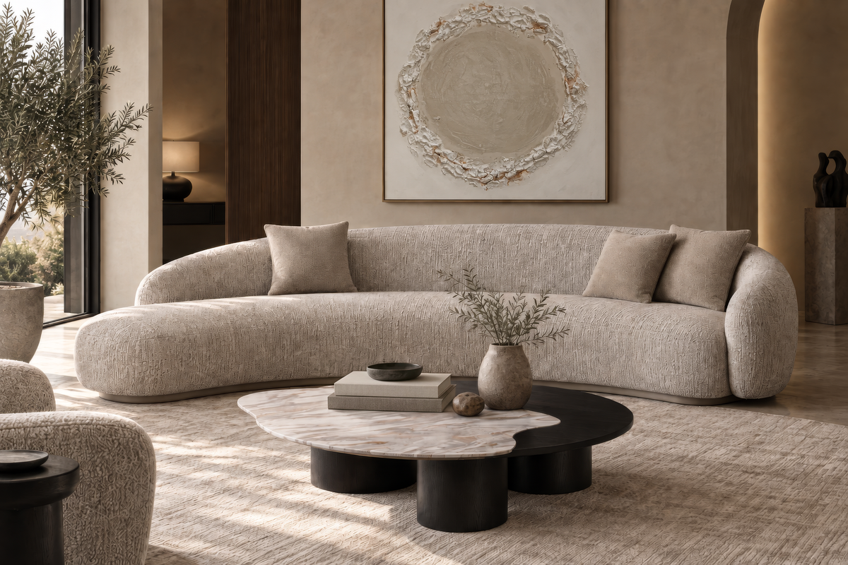 The Varenna Sofa in grey chenille with a leather base band, angled view