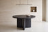 The Vinci Black Oak Round Dining Table in a dining room setting