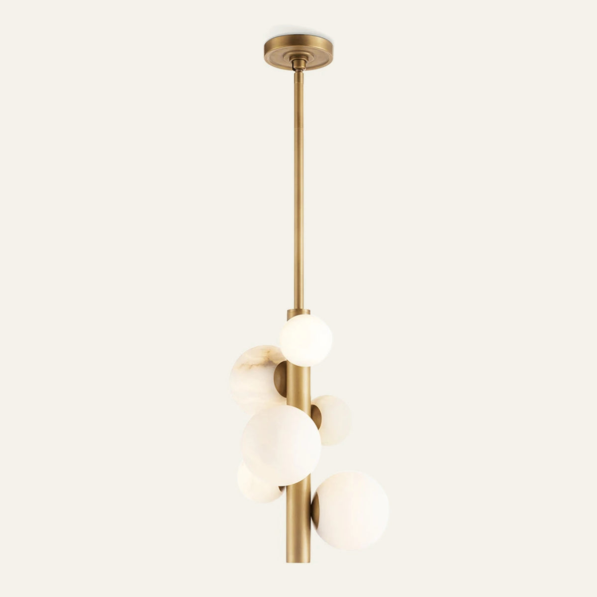 The Totem alabaster pendant light in brass, six stone spheres around a vertical rod