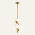The Totem alabaster pendant light in brass, six stone spheres around a vertical rod