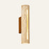 The Tronco travertine wall light with a walnut mount