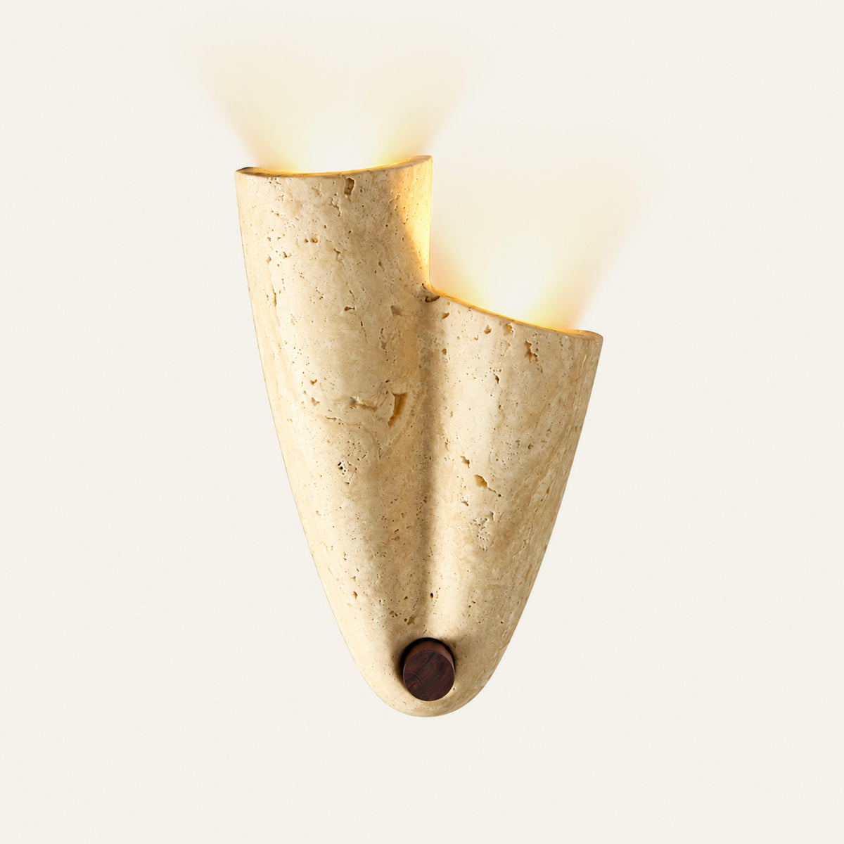 The Ventaglio travertine wall light, a folded stone cone with a walnut tip